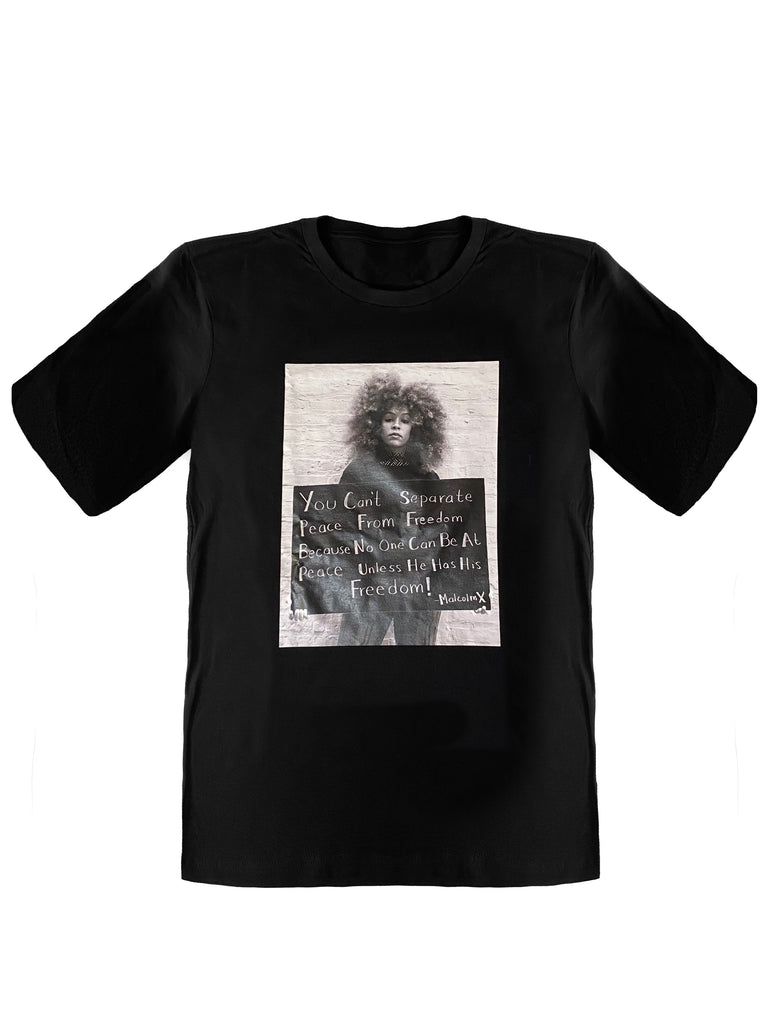 Short sleeve cotton T-shirt in black. Rib knit crewneck collar. Front printed image Diaspora founder holding Malcolm X's famous quote. Color: Black 100% cotton. Imported. Printed in Brooklyn , New York.